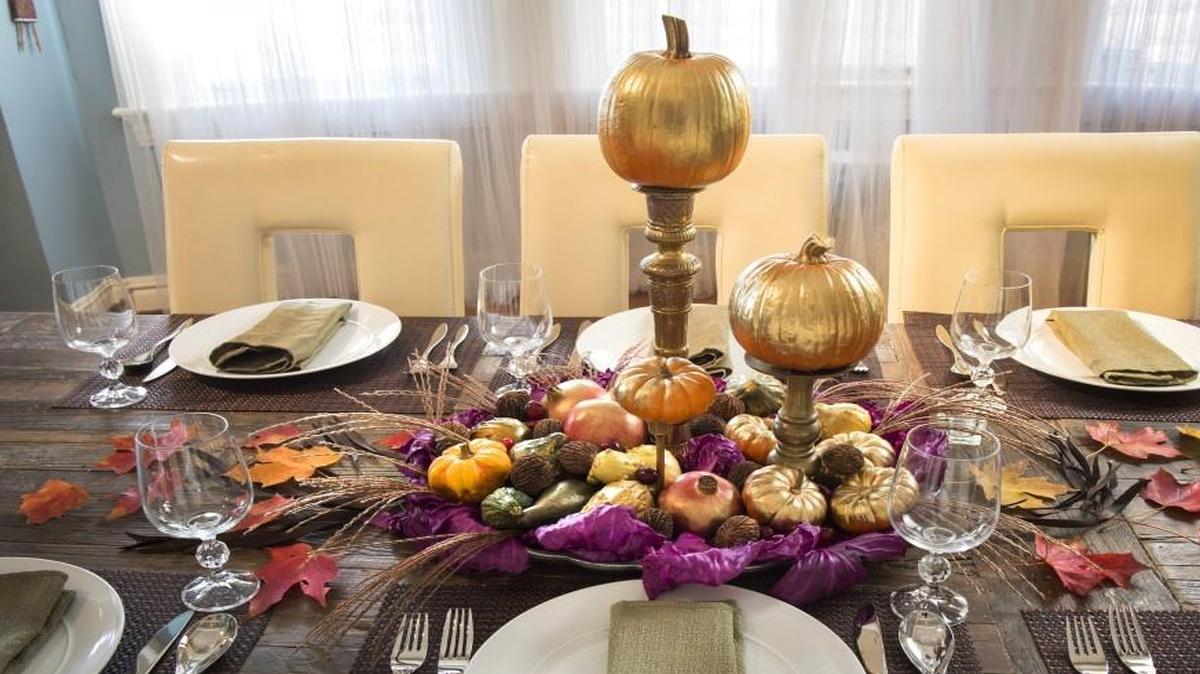 Create a centerpiece for your Thanksgiving table with painted pumpkins placed atop candlesticks and surrounded with more seasonal accents.