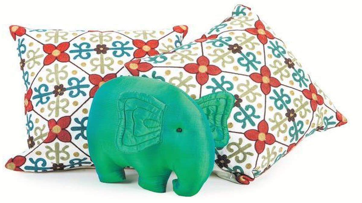 
The hand-embroidered pillow covers came from a street vendor in Chiang Mai’s city center. The woman who sold them to me didn’t speak English so I don’t know anything about them. They, along with the green silk elephant pillow from Thai Silk Village, a factory where you can see silk being produced from worm to weaving, will add a much needed splash of color to my muted living room. 


