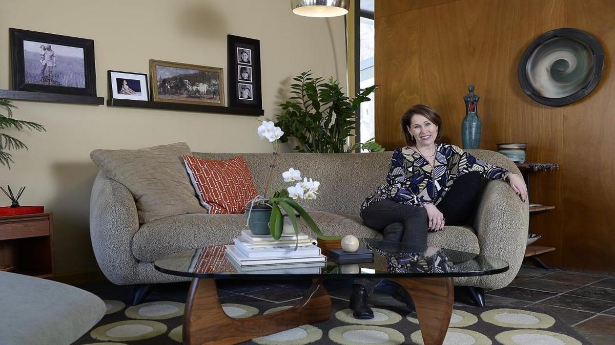At home in the mid-century modern home of SueAnn Heim, a home stager, who lives with her husband, daughter and two cats in Prairie Village.