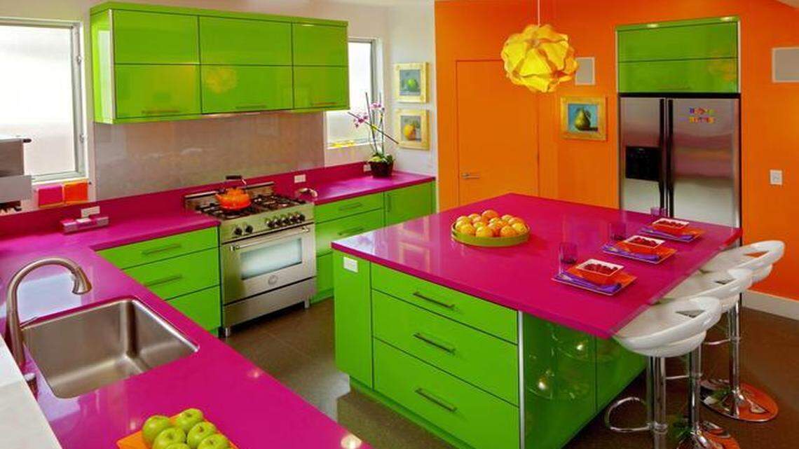 Karen and Brian Frid-Madden envisioned their kitchen as an almost Alice in Wonderland-like gathering place. Iridescent tiles, silver-painted backsplash and stainless steel complement the neon color palette.<252><252>
