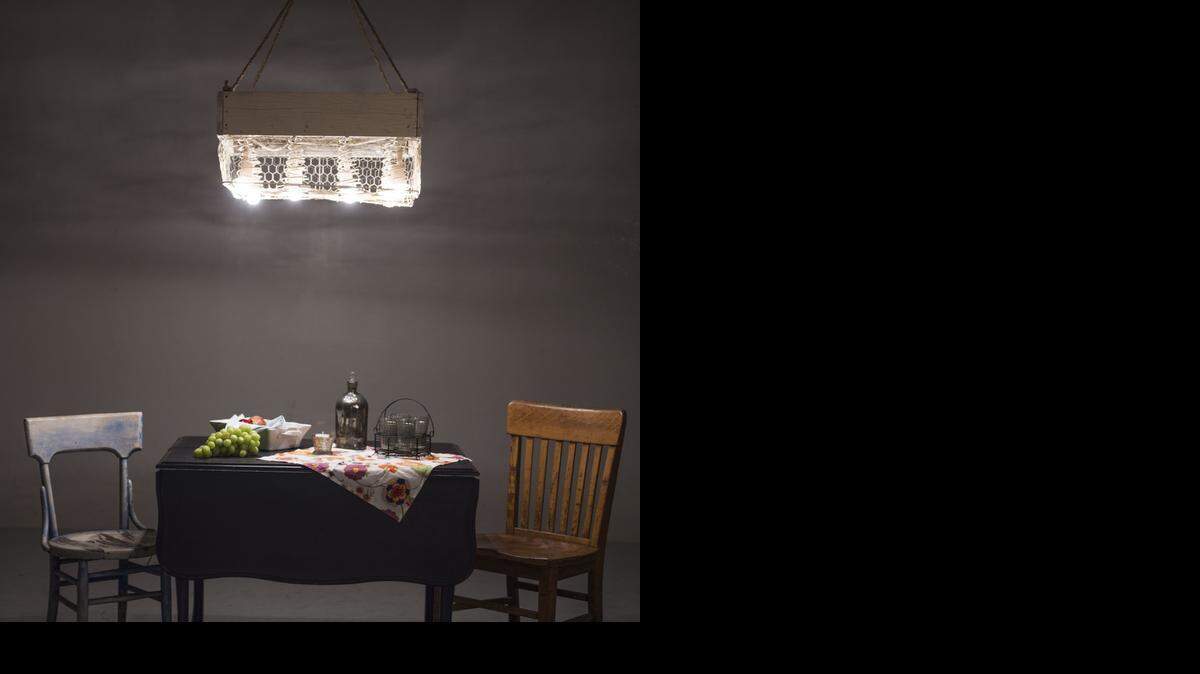 
Eric Rigdon and Shannon Myers, owners of Charm in Martin City, created a rustic chandelier using an old wooden box, a bed spring and chicken wire. 
