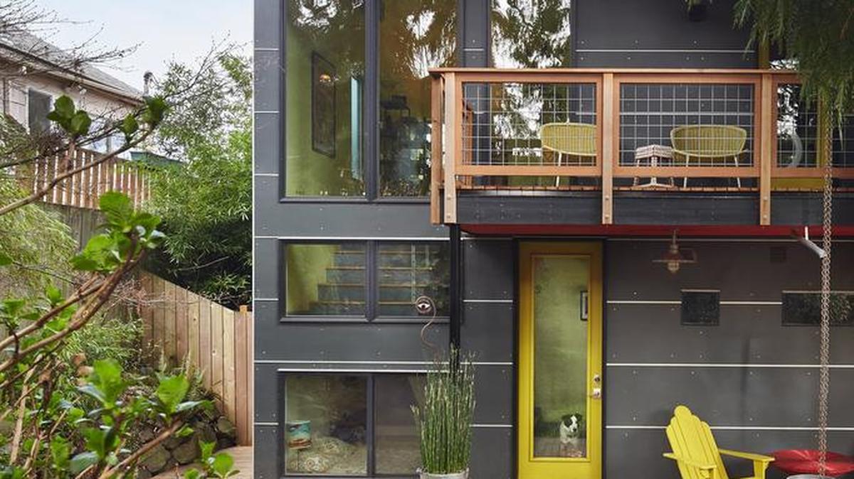 The backyard of The Clubhouse is a bit of a sanctuary, architect Tim Hammer says, with greenery galore and a waterfall that obscures street noise. Inside, just to the left of the sunshiny back entrance, lies The Drunk Tank, a step-down guest room tucked underneath the stairs.