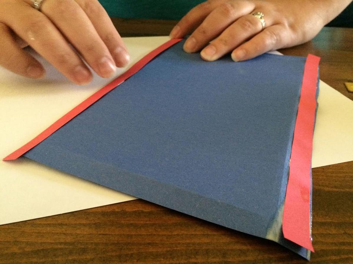 Fold the edges of the paper about a half inch.