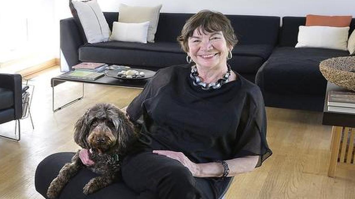 
Textile artist Jennie Frederick with her chocolate labradoodle pal, Rosarita, relax in Frederick’s Kansas City, North, home.
