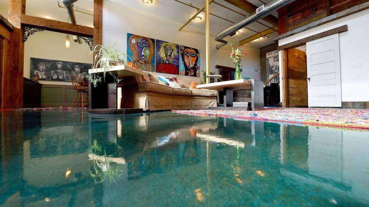 Gleaming concrete floors stained a brilliant turquoise are a feature of the Crossroads home of Karla Deel and Sterling Witt.