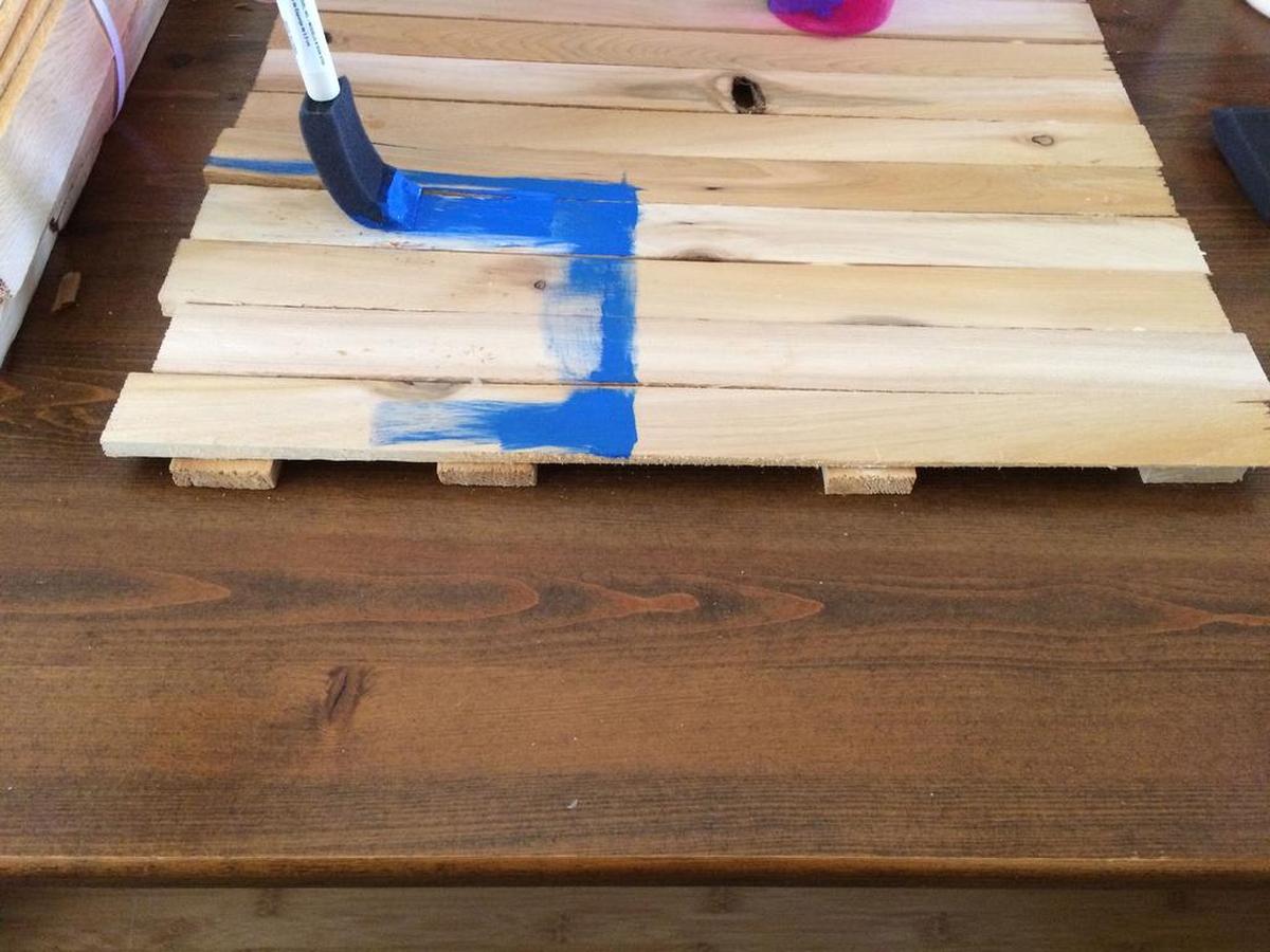Paint a blue square in one corner.