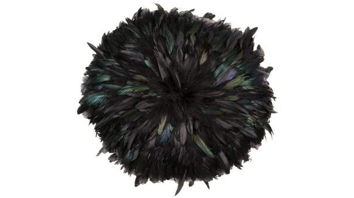 Rooster feathers have been dyed a deep ebony hue and affixed to a linen-backed pillow by Jayson Home. A rectangular version features gold metallic feathers and is backed in velvet.