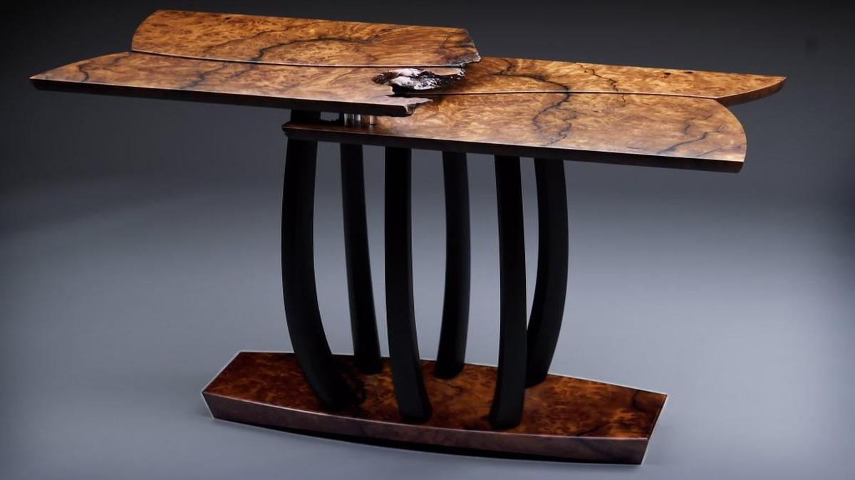 The materials used to make this table included redwood burl, ebonized mulberry legs and acrylic dowels.