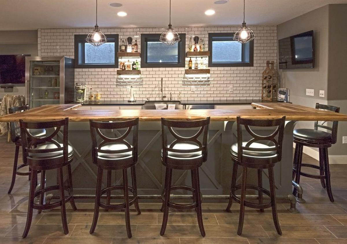 The fully finished basment features a full kitchen and bar.