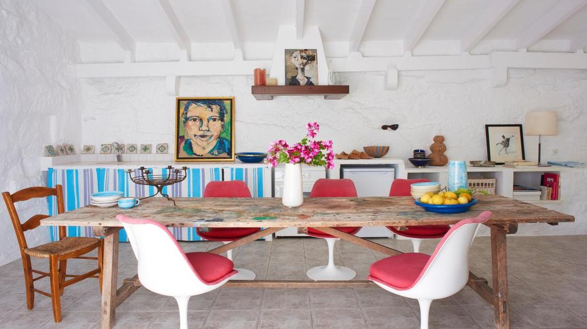 The dining room of this Mediterranean home on the Spanish Balearic island of Menorca is featured in Will Taylor’s book, “Dream Decor: Styling a Cool, Creative and Comfortable Home, Wherever You Live. The Saarinen Tulip chairs pop against the weathered wooden dining table.