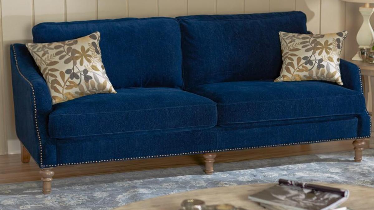 Indigo remains an appealing alternative to black. Here, the Lark-Manor Lavande sofa from Wayfair is paired with cream or gray for a soft, modern statement.