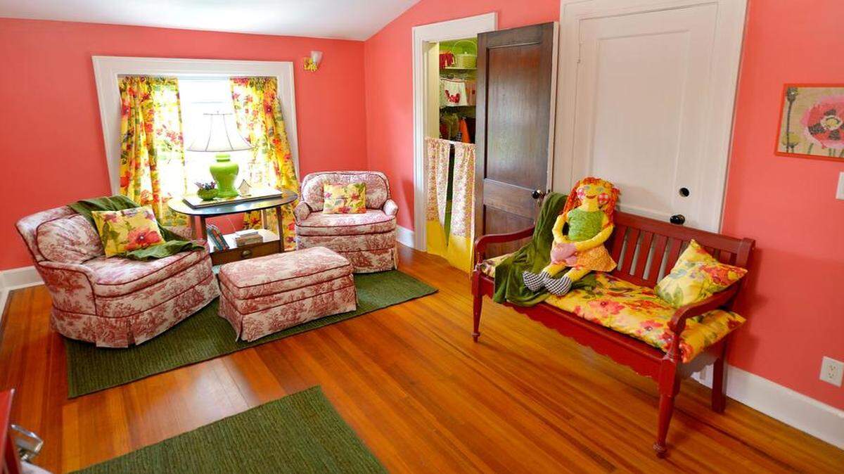 
Kitty Sondern Snyder, a children’s dressmaker in Prairie Village, based the colors in a third-floor girl’s bedroom in the Symphony Designers’ Showhouse on the bright floral drapery fabric. The waist-high curtains leading into the closet create a makeshift stage.

