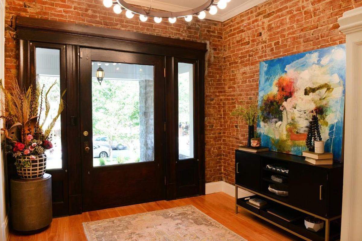 The foyer now has exposed brick walls.