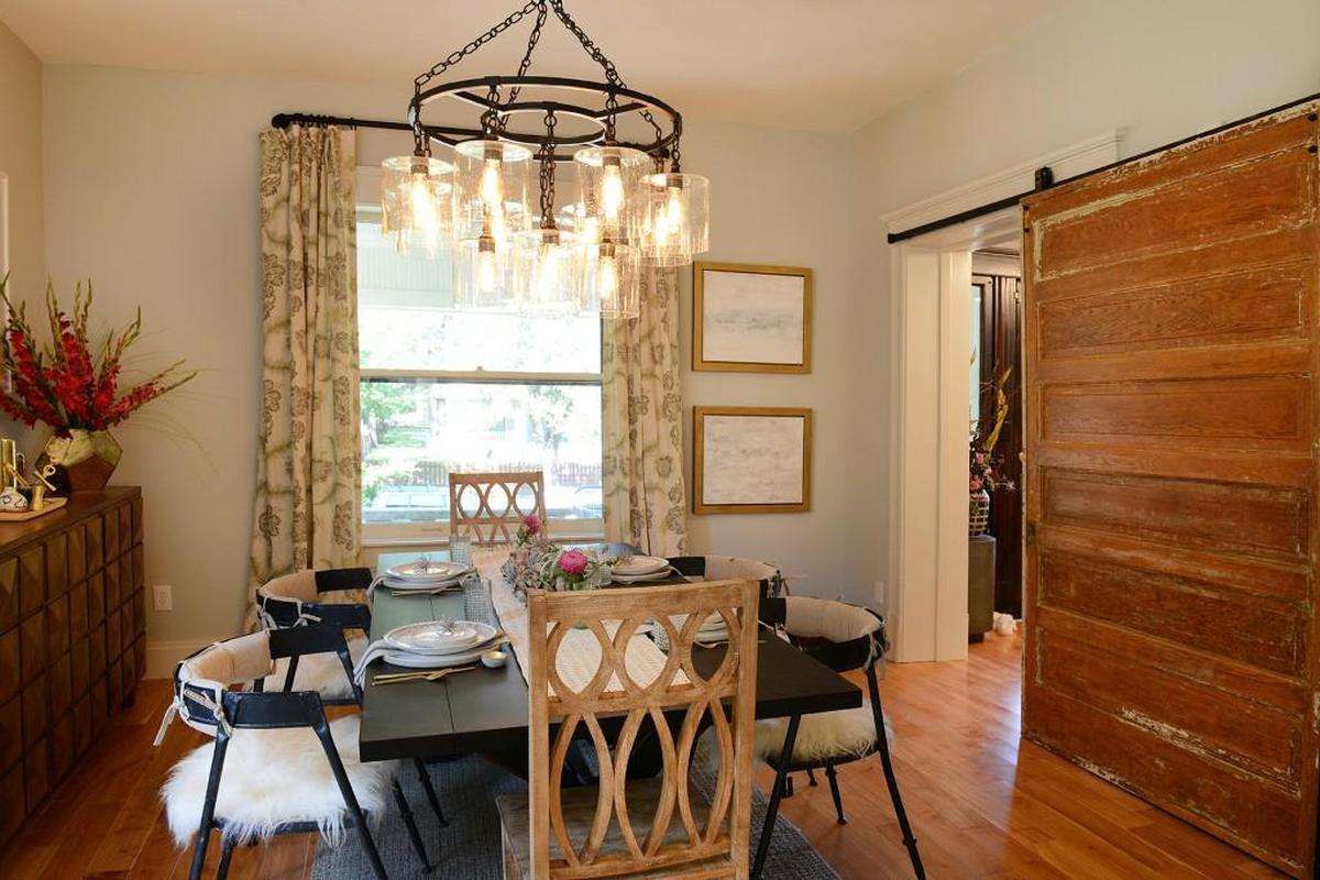 The dining room has an old French country feel, thanks to the barn door Day had installed in the dining room.