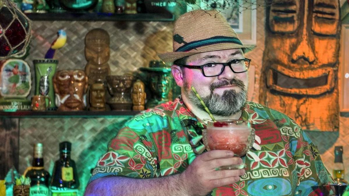 Tiki fan Corey Whitworth has created a hideaway he calls The Flora Lounge in the basement of his Kansas City home. It features a collection of memorabilia such as ceramic tiki mugs, wood carvings, albums and fish netting.