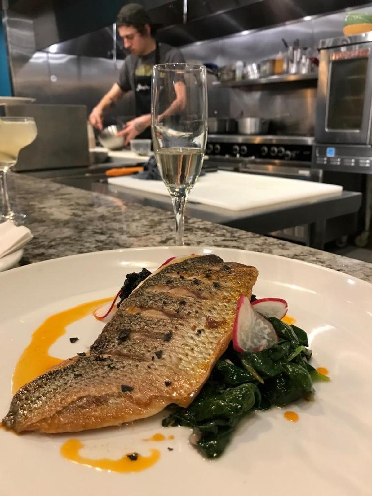 The view from the chef’s table: Sea bass filet was the special one night. It was served with fresh locally grown greens and sliced radish.