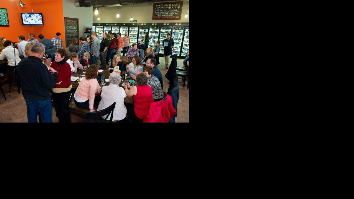 
Beer lovers filled the lobby of Bier Station at 120 E. Gregory Boulevard in Kansas City, Mo. where customers can choose from a rotating selection of craft beers. The bar also features an in-hour liquor store where customers can purchase bottled beer (in refrigerated cases at background center). 
