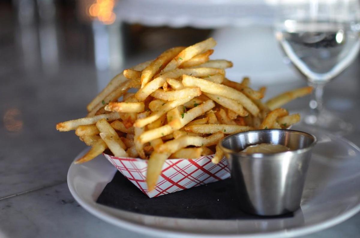 Ça Va’s pommes frites are made with a recipe inspired by McDonald’s. They’re crispy on the outside, soft on the inside and served with a sprinkle of parsley and a cup of house-made aioli.