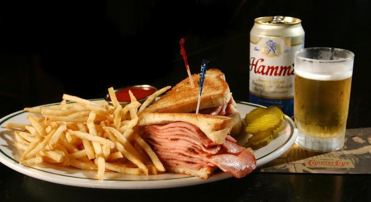 Harry’s Country Club’s fried bologna sandwich costs $6.95 with a side of fries.