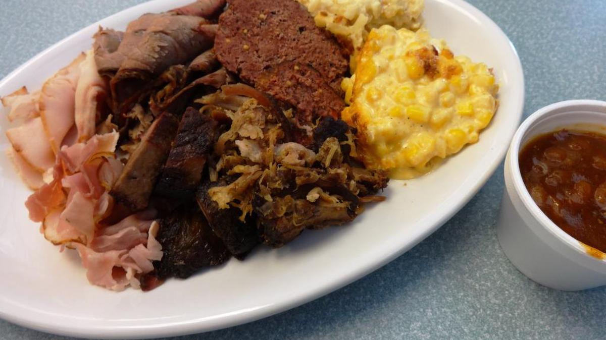 
Fireside’s What-Not Sampler meat medley of ham, turkey, brisket, burnt ends, pulled pork and homemade sausage with cheesy corn, cheesy potatoes and baked beans on the side.
