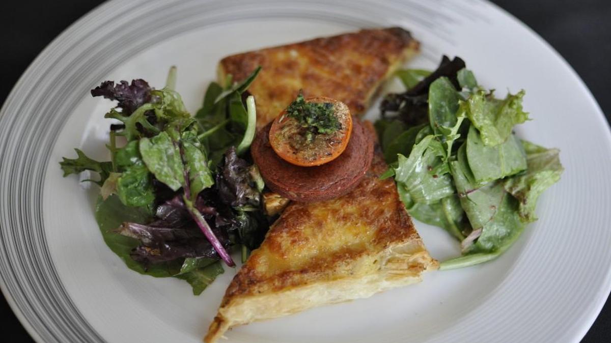 The lunch menu at Parkville’s Cafe Des Amis features Quiche Lorraine made with 36-hour house-poached ham.