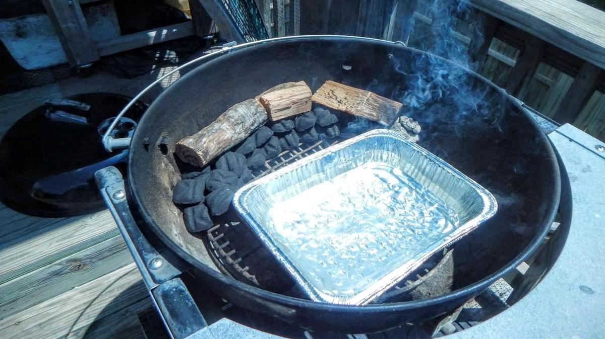 
Using the “snake method,” you start with layers of charcoal stacked on top of each other with pan of water on the non-fire side.
