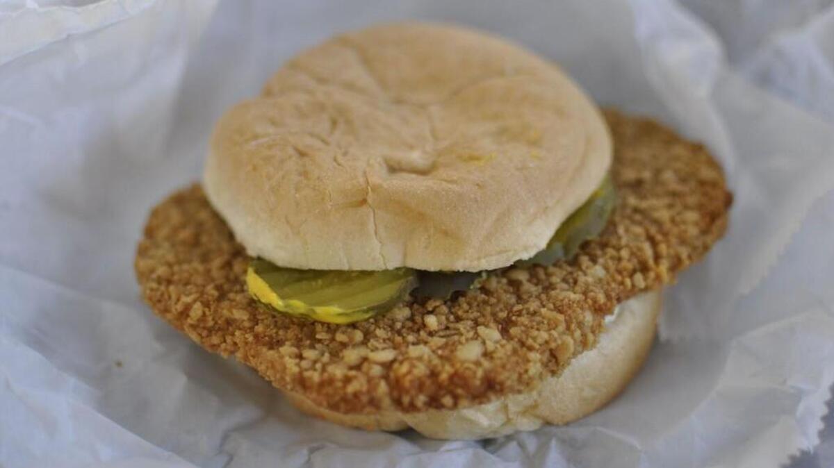 Mugs-Up is known for loose-meat burgers, but the Independence drive-in also serves oversized pork tenderloins topped with pickles, mustard and onions.