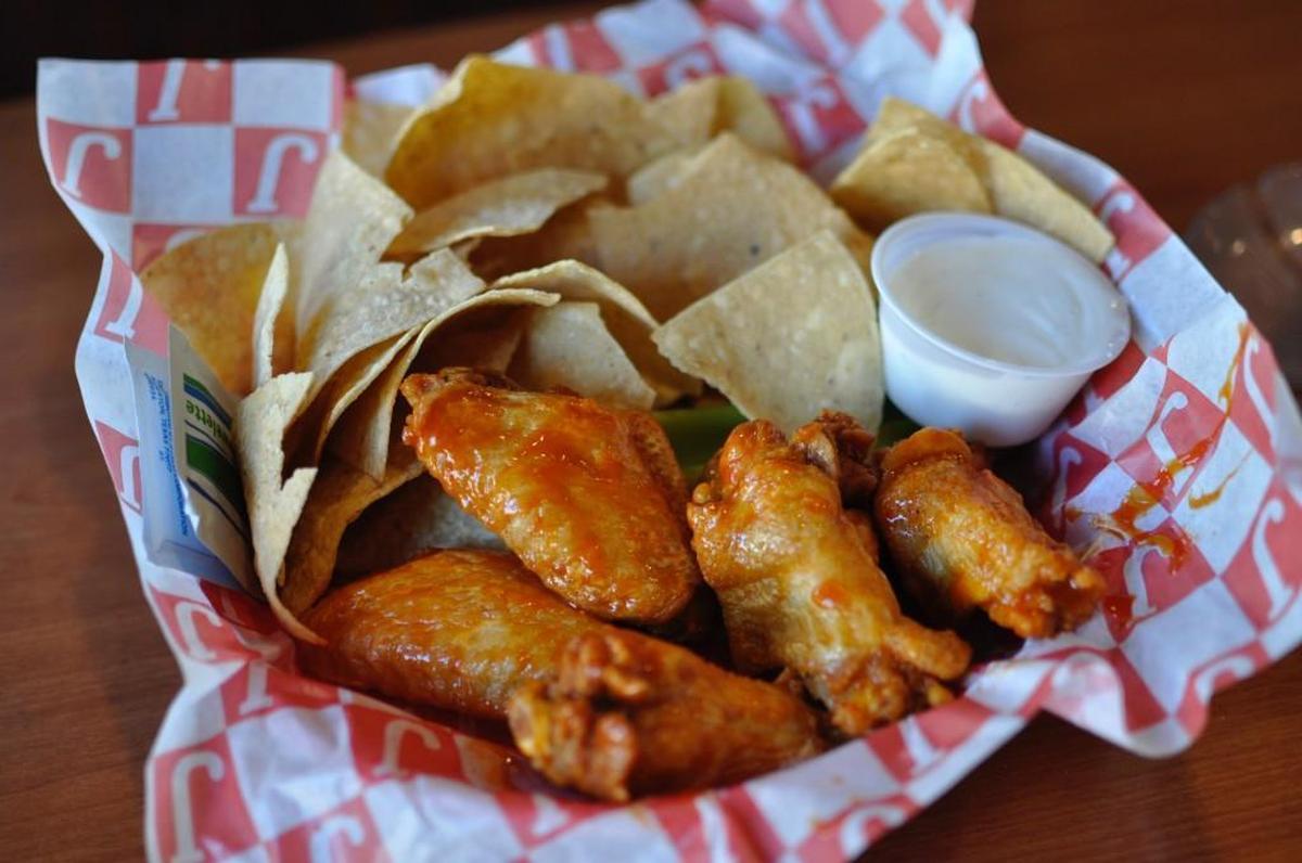 At Jefferson’s, a national chain of sports bars with two locations in Lawrence, the motto is “peace, love and hot wings.” The wings come in 19 flavors — if you like a classic Buffalo-style wing, skip “afterburner” and “mango habanero” and just ask for “hot.”
