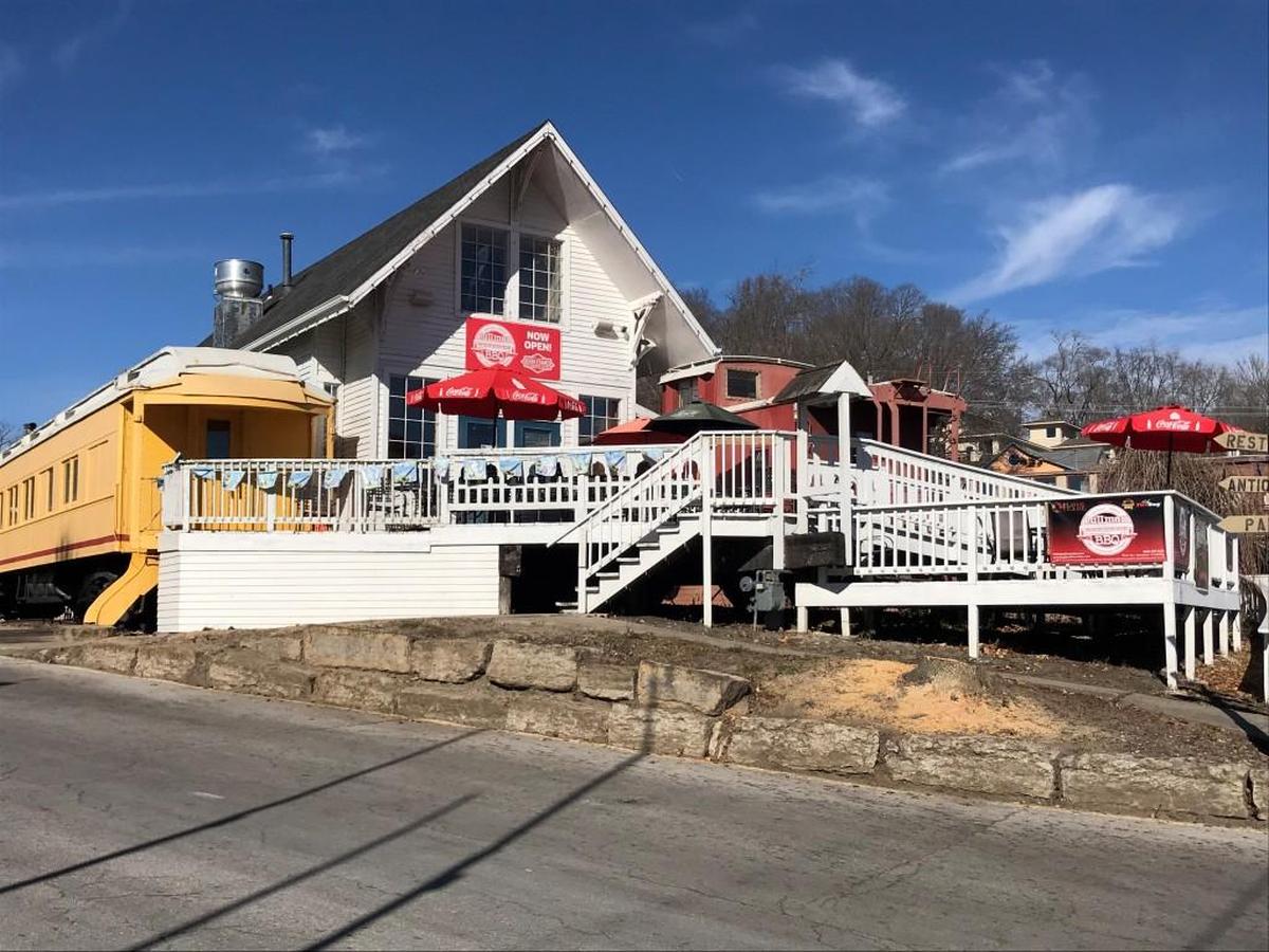 Pullman BBQ in Parkville is the fusion of a Pullman dining car and caboose with a wood house and deck.