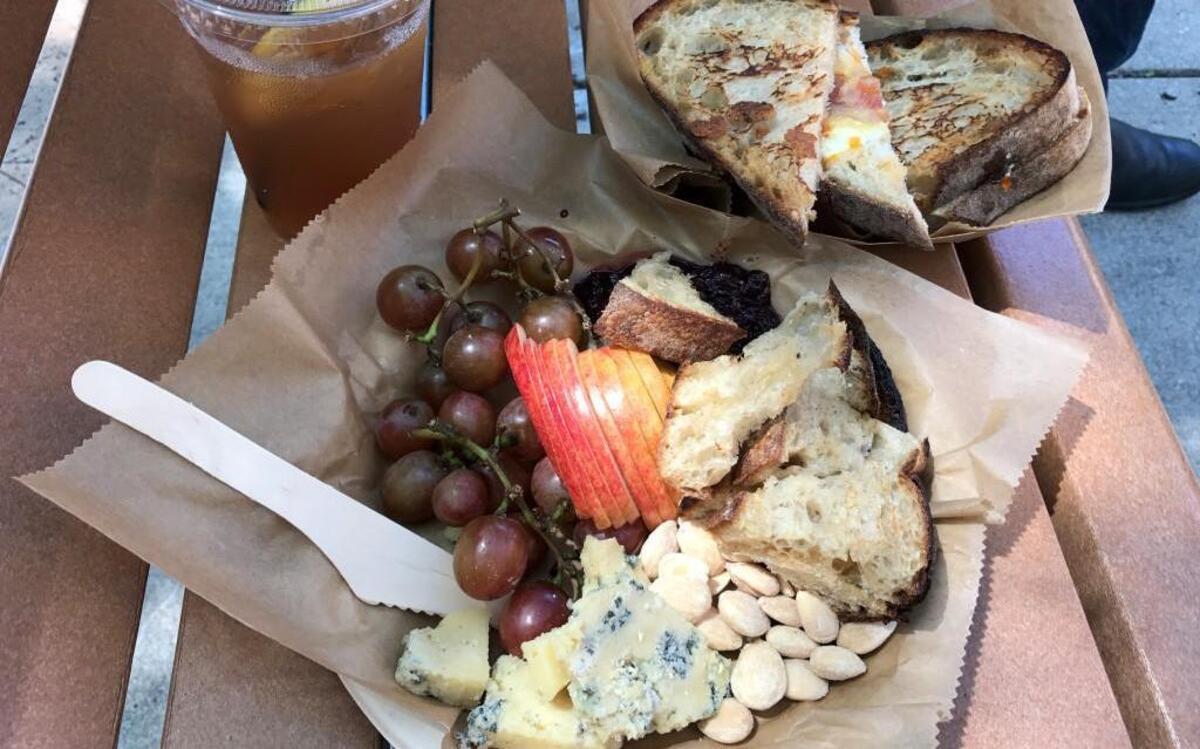 An Ash & Bleu cheese plate featuring Ozark Mountain blue cheese by Edgewood Creamery in Purdy, Mo. Other accompaniments include grapes, apple, marcona almonds, jam and Ibis toast. Also on the menu: grilled cheese sandwiches.