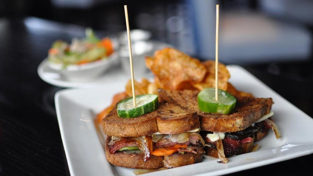 Grand Street Cafe’s pastrami sandwich is served on marble rye with Gruyere cheese, house-made giardiniera, horseradish aioli and Worcestershire steak sauce.