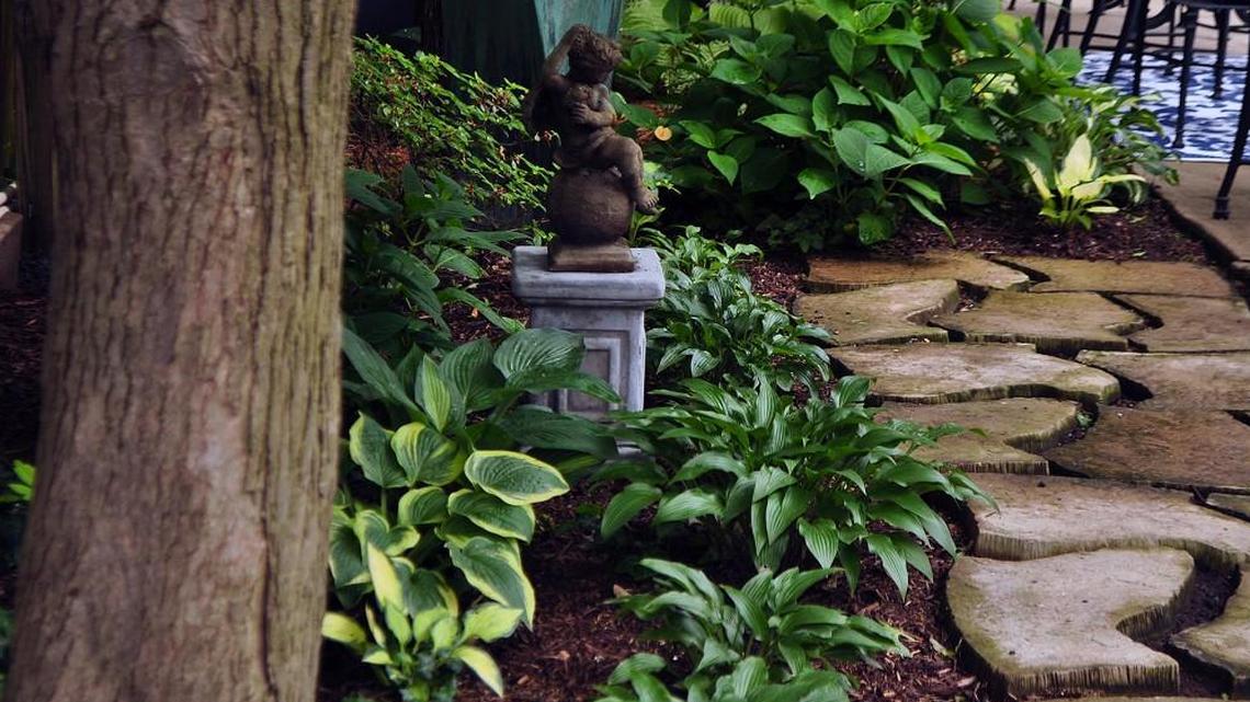 Sometimes a path provides a good vantage point to enjoy a garden ornament.