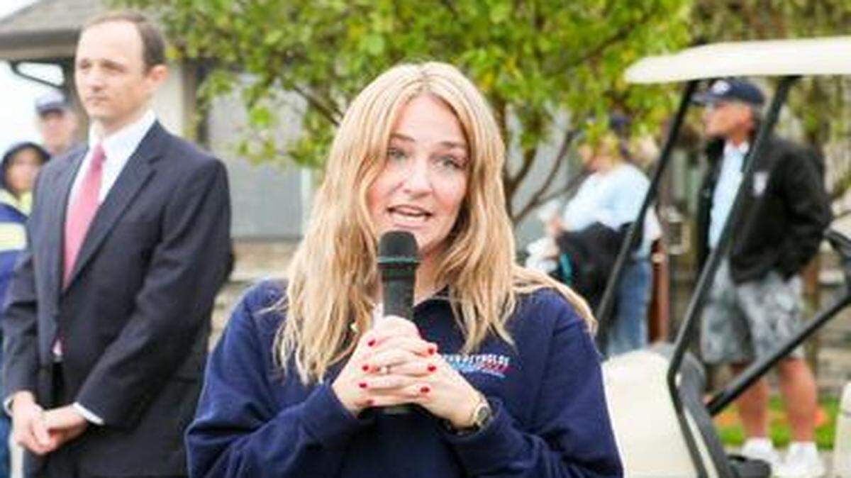 Erin Reynolds spoke to participants at the Fore Your Heart golf tournament in Raymore in October. The event in honor of her husband, John, who died at 42 of undetected heart disease, raised $40,000, which was split between two charities. <252><252>