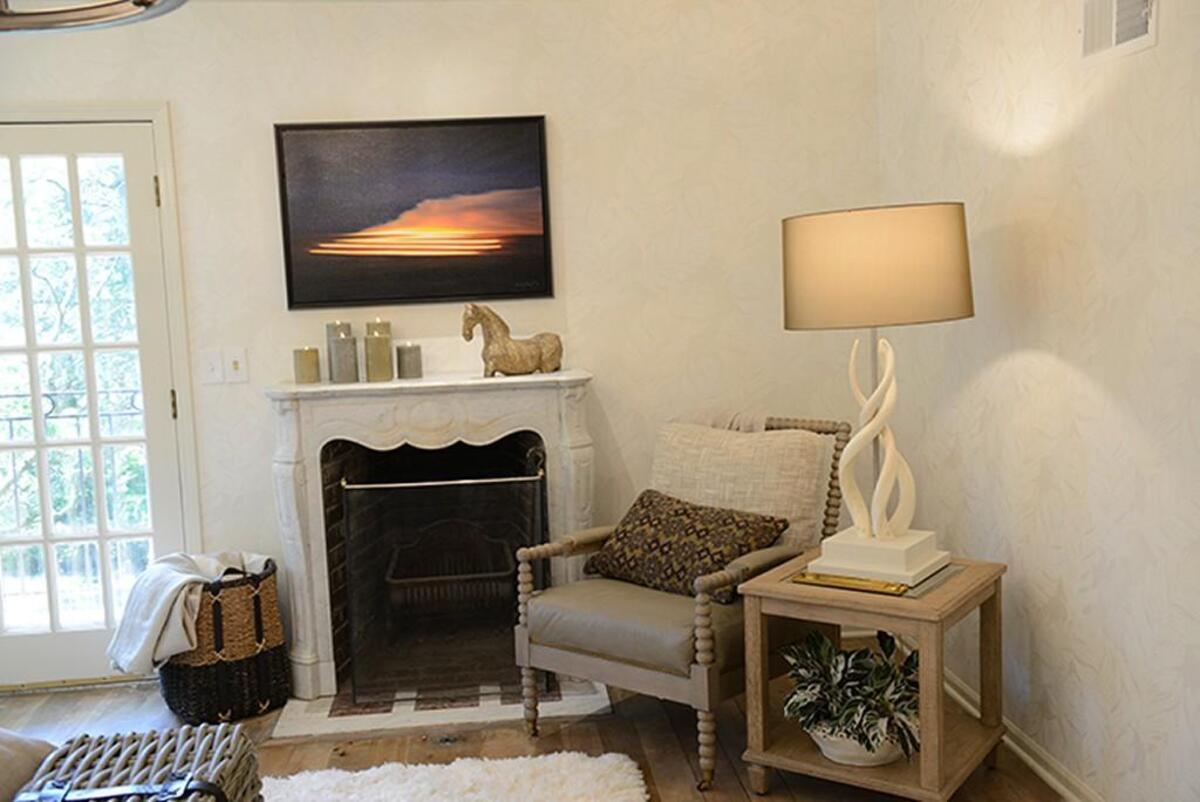A fireplace and chair make for a nice reading area in the master bedroom of the Leawood home.