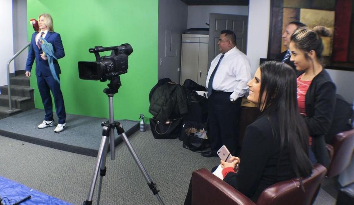 Lauren Sierra Kruskall (right) smiled as she watched fiance Tristen Woods, aka Tarzan the Lawman, shoot scenes for a Spanish language commercial. The couple’s firm, Jungle Law Group, specializes in animal rights.