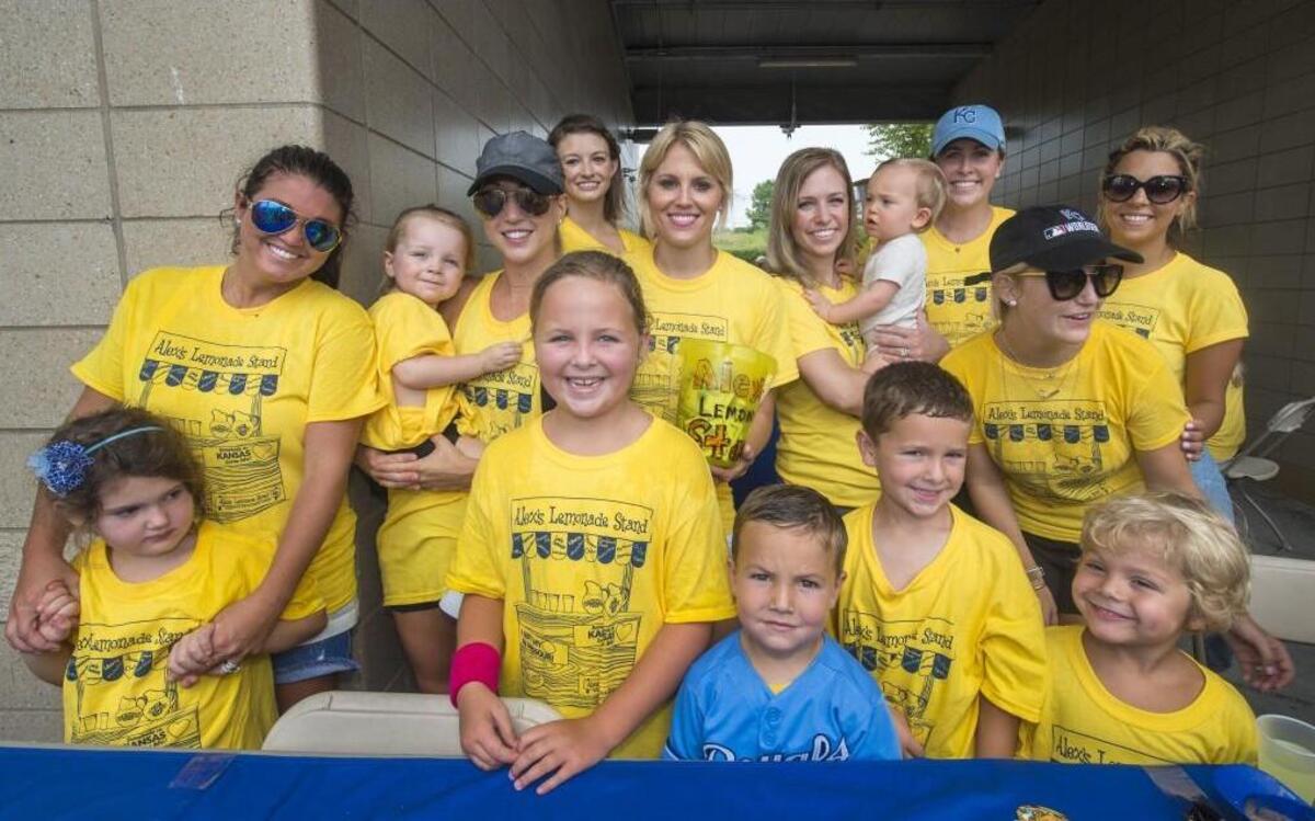 
Royals wives and children were on hand to help with the Alex’s Lemonade Stand fundraiser during the Royals-White Sox game on Aug. 9 at Kauffman Stadium. The fundraiser included selling lemonade and Royals-autographed baseballs. The wives and children (from left, front row) include children Lanie Hochevar, 5; Kate Young, 7; Grant Young, 5; Scott Young, 5; Max Gordon, 4. Second row includes Ashley Hochevar, Katelyn Davis with Sully, 2; Jordan Clark ; Jamie Gordon; Tiffany and Ronan Collins, 10 months; Liz Young; Stephanie Moustakas and Sara Duffy.
