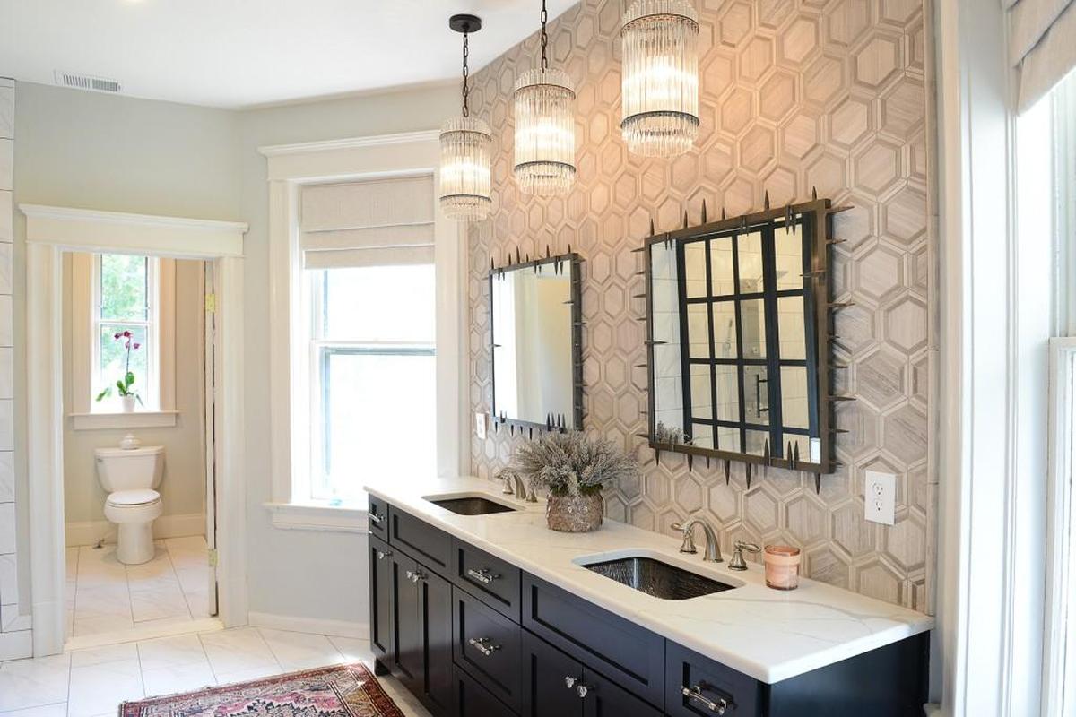 The three crystal chandeliers over the double vanity lend the master bathroom a French chauteau feel.
