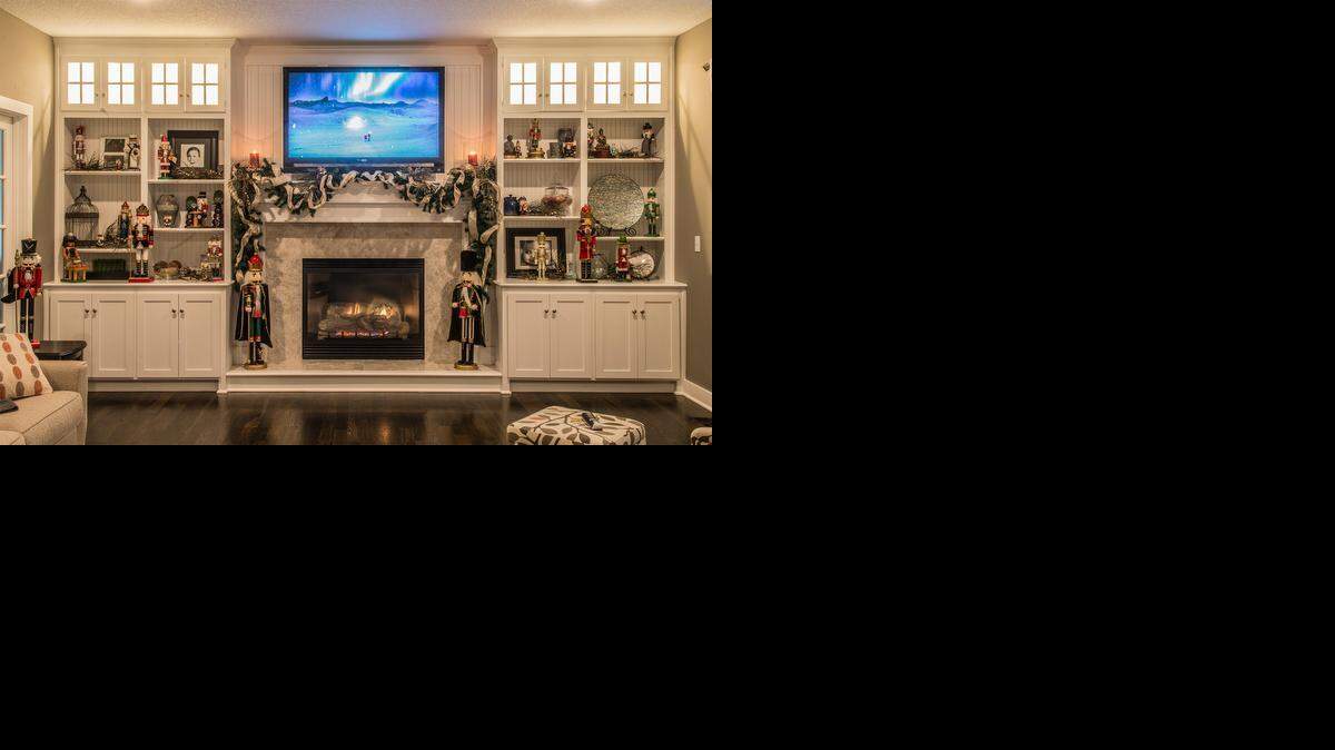 
John Shackelford with Shackelford Botanical Designs said he wanted to work with the Cremers’ “elegant home.” Here, he arranged Rob Cremer’s collection of nutcrackers, from toy to toddler size, around the fireplace.

