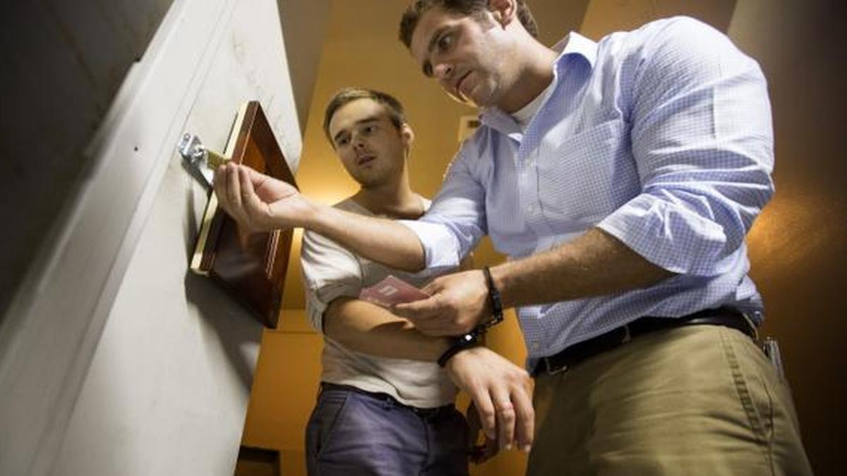 
Alex Belousov, left, and AP writer David Fischer try to unlock a box as they play a game at Escape the Quest in Miami Beach, Fla. 
