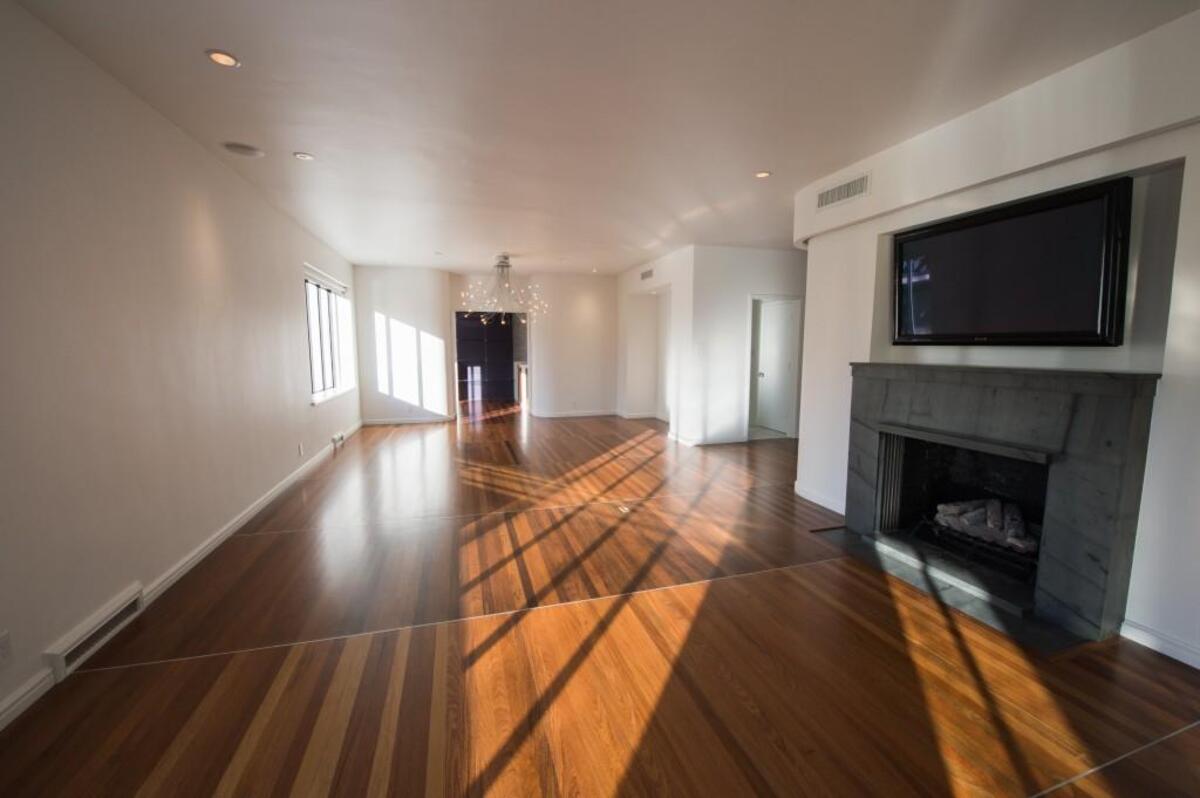 The living room, now open to the dining room, sports its original Kentucky bluestone fireplace mantel. It’s simple, linear design feels more fresh and modern than most contemporary mantels.