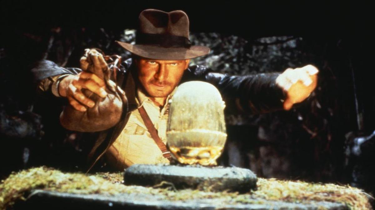 Indiana Jones (Harrison Ford) prepares to swipe a golden idol and, in the process, bring down an ancient stone temple in “Raiders of the Lost Ark.” Props from the Indiana Jones movies and real archaeological finds are on display in “Indiana Jones and the Adventure of Archaeology” at the National Geographic Museum in Washington, D.C.