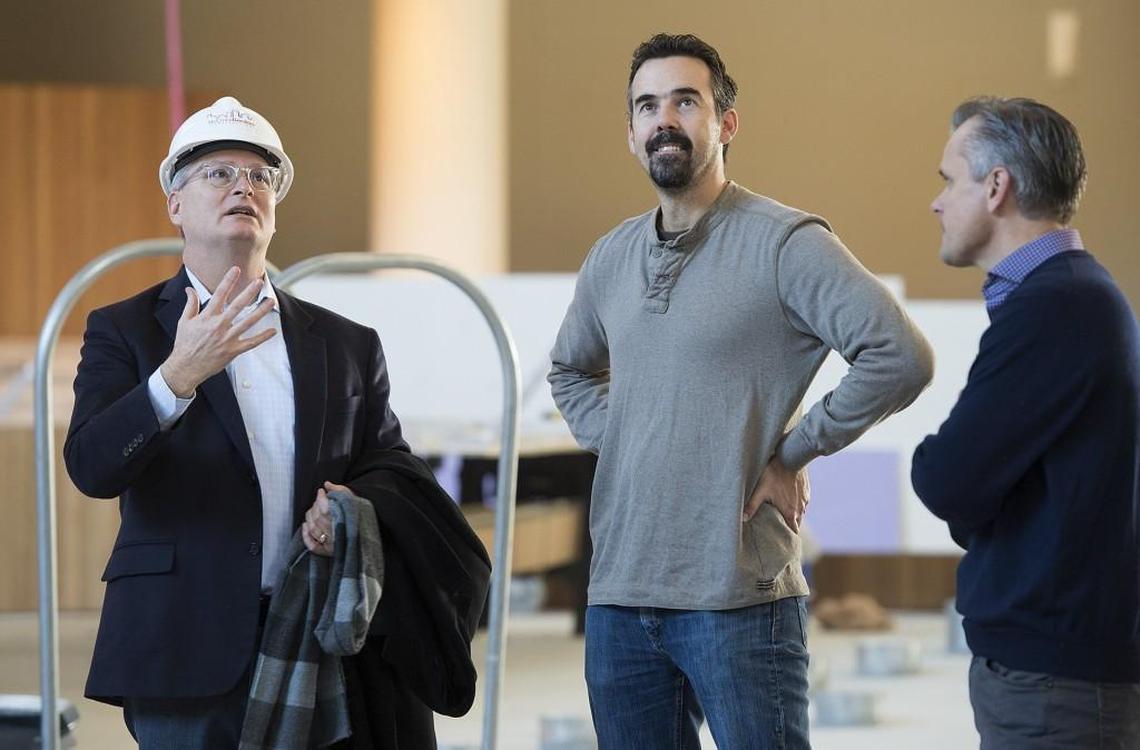 From the floor of the new sanctuary at the United Methodist Church of the Resurrection, the Rev. Adam Hamilton (from left), senior pastor, talks with Tim Carey, lead designer, and David Judson of Judson Studios as a new stained-glass window is being installed. Carey designed the new Resurrection Window.