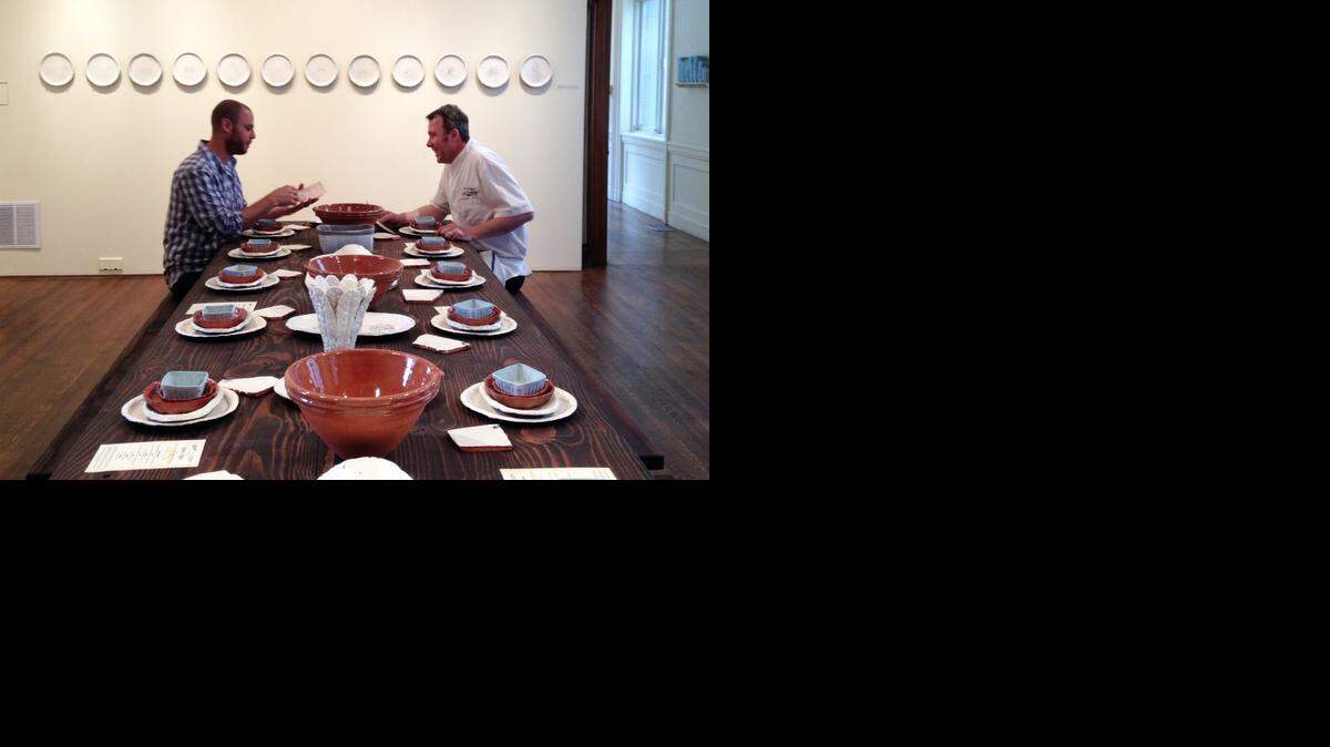 
At the Philadelphia Art Alliance, chef Pierre Calmels (right) cooks a seven-course, $150 meal served on fine ceramic pottery created by artist Gregg Moore (left). The dinner and pottery are part of the social practice art movement.
