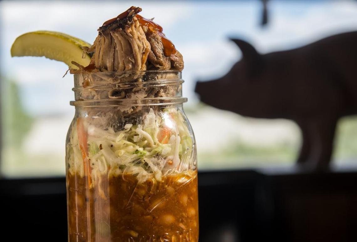 BB's Lawnside BBQ serves a barbecue sundae layers of hickory-smoked pit beans, coleslaw and pulled pork in a mason jar. Barbecue sauce and a pickle spear sub for a cherry on top.