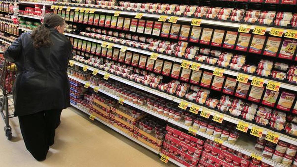 
A shopper walks down the canned soup aisle at a grocery store in Cincinnati.
