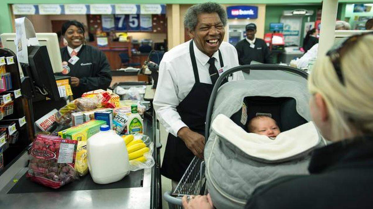
Cosentino’s Price Chopper sacker Calvin Knox had a big smile recently for Abby Eubank and her 5-week-old daughter, Caroline, at the store at 103rd Street and State Line Road.


