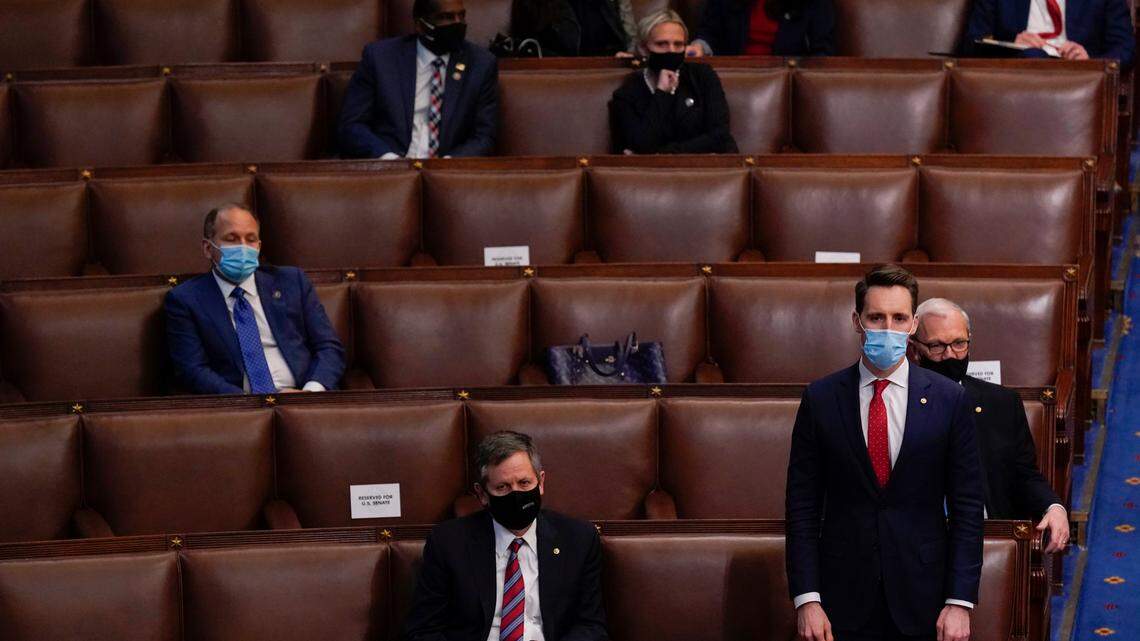 Sen. Josh Hawley, R-Mo., rises to join House Republican members to object to confirming the Electoral College votes from Pennsylvania during a joint session of the House and Senate to confirm the Electoral College votes cast in November’s election, at the Capitol, early Thursday, Jan 7, 2021, in Washington.
