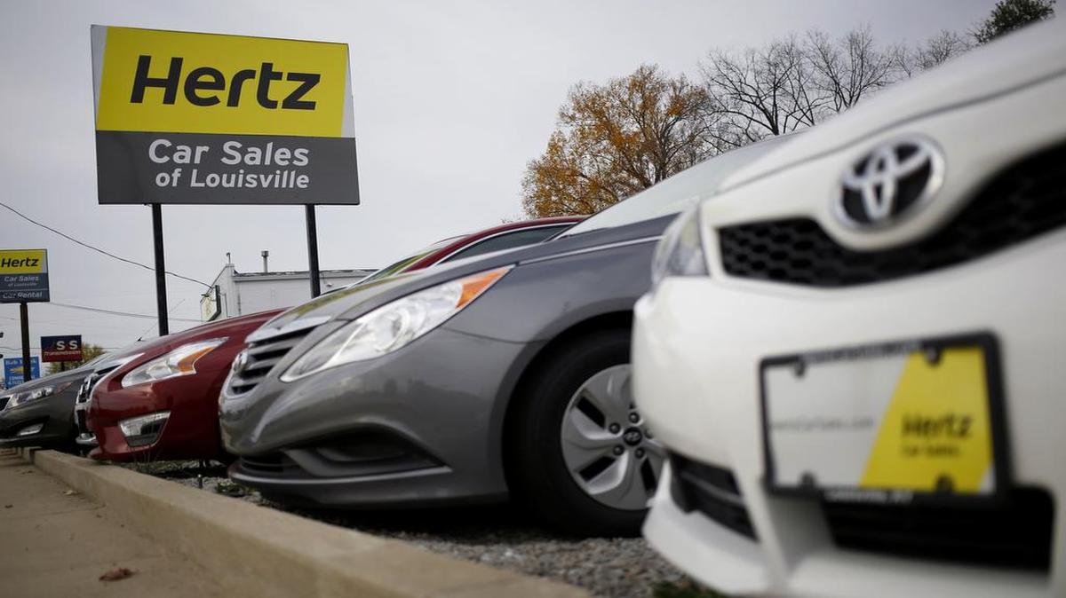 Vehicles sit parked at a Hertz rental car and sales location in Louisville, Ky.