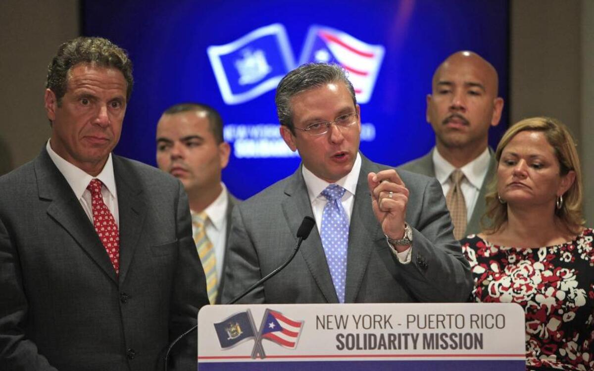 
Gov. Andrew Cuomo of New York (left) and a delegation of state officials met with Gov. Alejandro García Padilla of Puerto Rico (center) on Tuesday to help Puerto Rico emerge from a deepening economic crisis.
