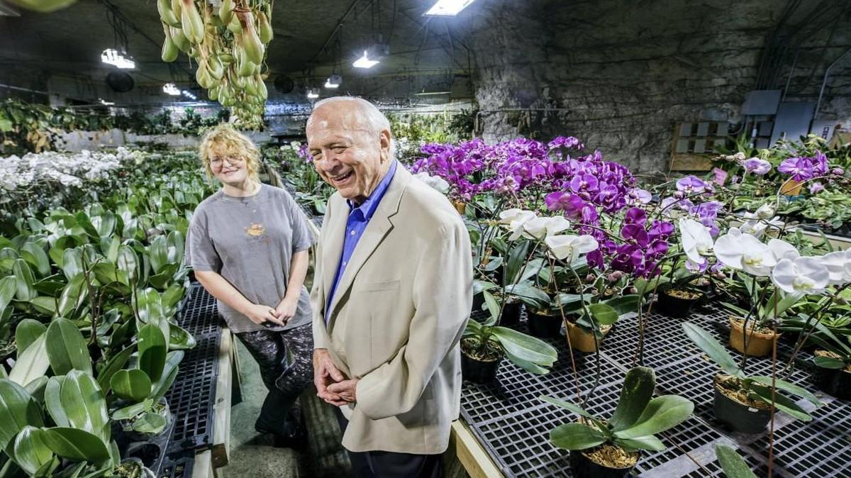 Wayne Reeder (right) among the orchids with horticulturist Darci Ezell at Bird’s Botanicals in Interstate Underground in Kansas City. Reeder has owned Interstate Underground for more than four decades.